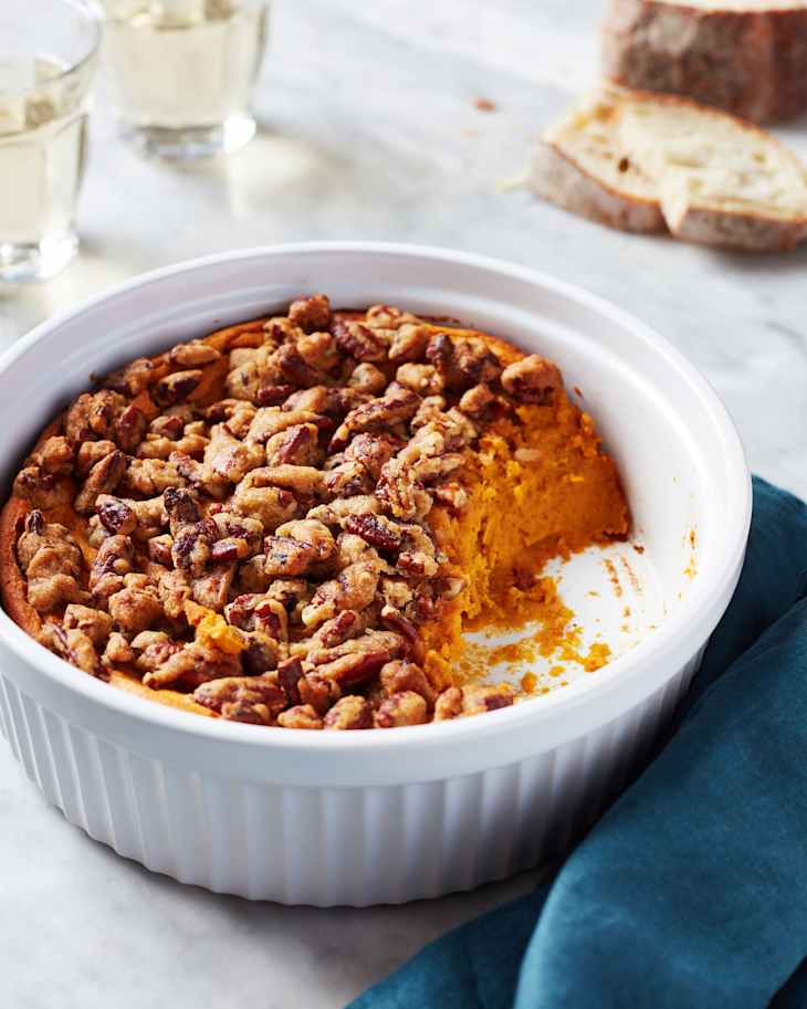 Sweet potato souffle in serving dish with serving scooped out.