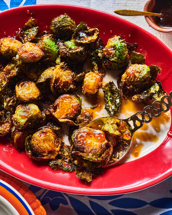 platter of deep fried brussels sprouts, drizzled with sauce