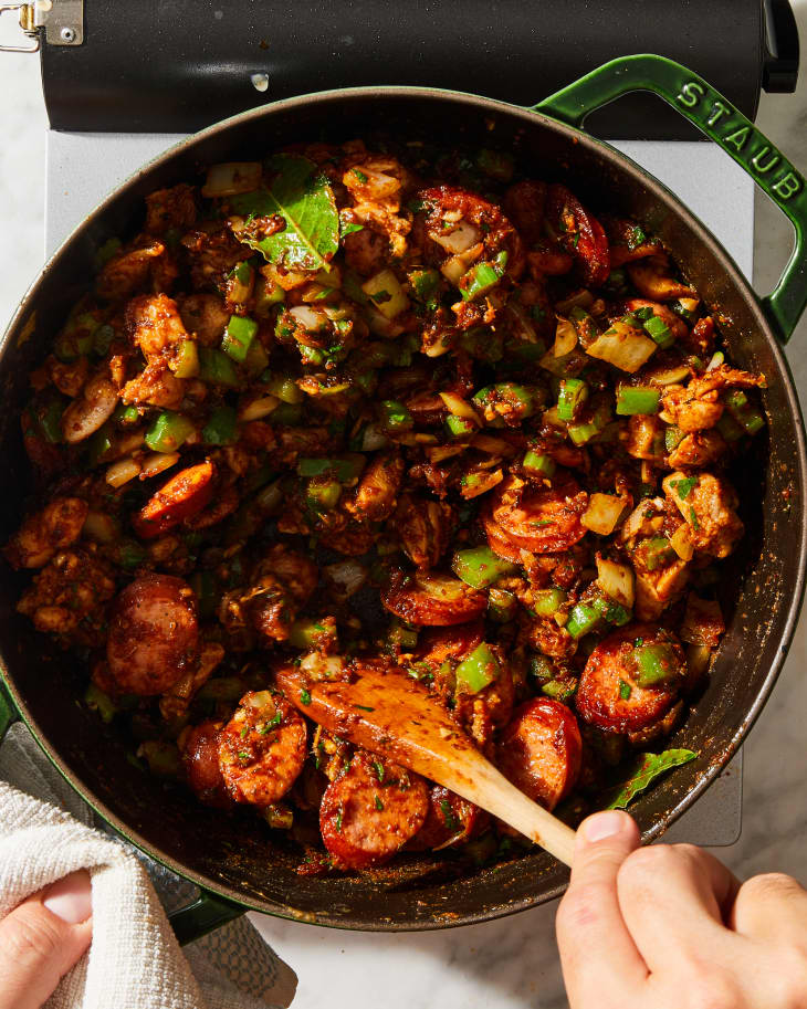 cajun gumbo being stirred in a pot