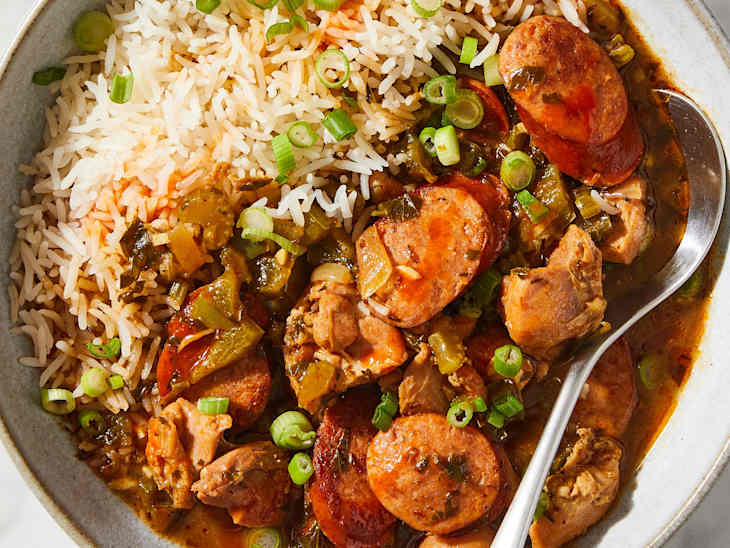 gumbo in a bowl with jasmine rice and a spoon
