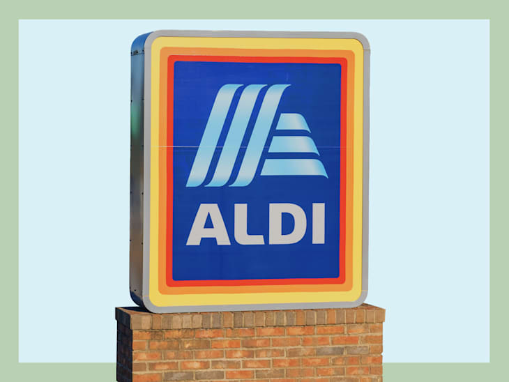 Aldi store sign featuring a blue background with white lettering, mounted on a brick base.