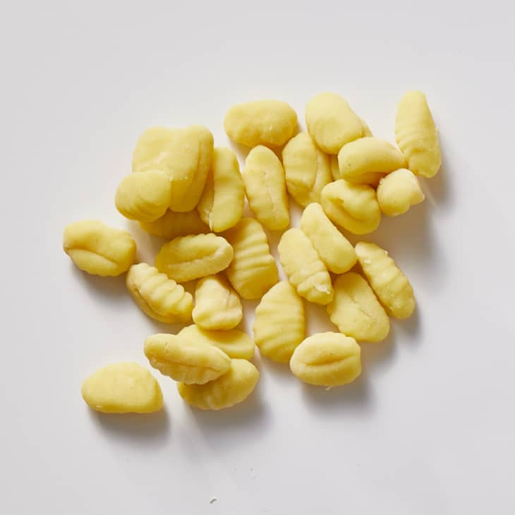 Gnocchi on a white surface.