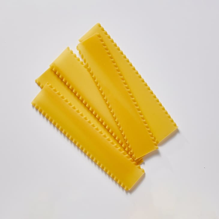 Lasagne on a white surface.