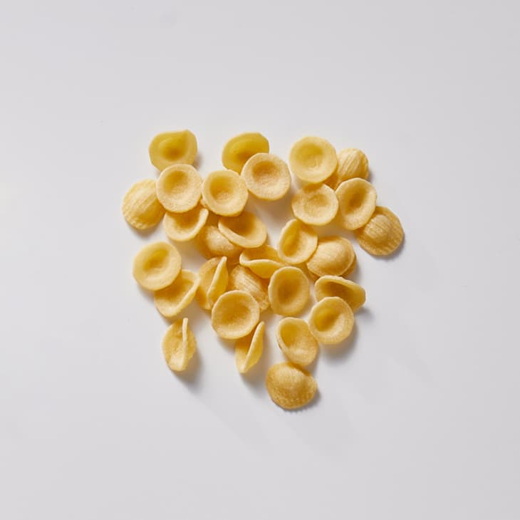 Orecchiette on a white surface.