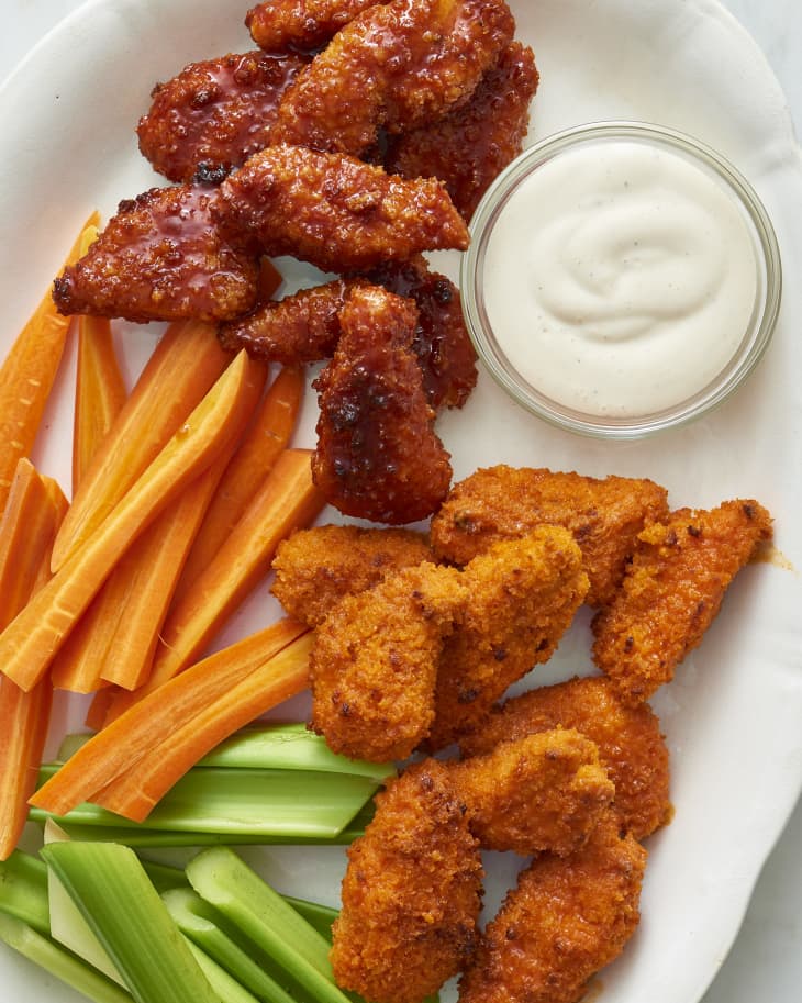 Boneless baked chicken wings coated in Frank’s RedHot® hot sauce and honey barbecue sauce, served with carrot sticks and celery, and a sauce on the side