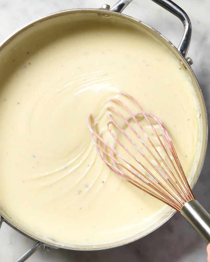 overhead shot of someone whisking the bechamel