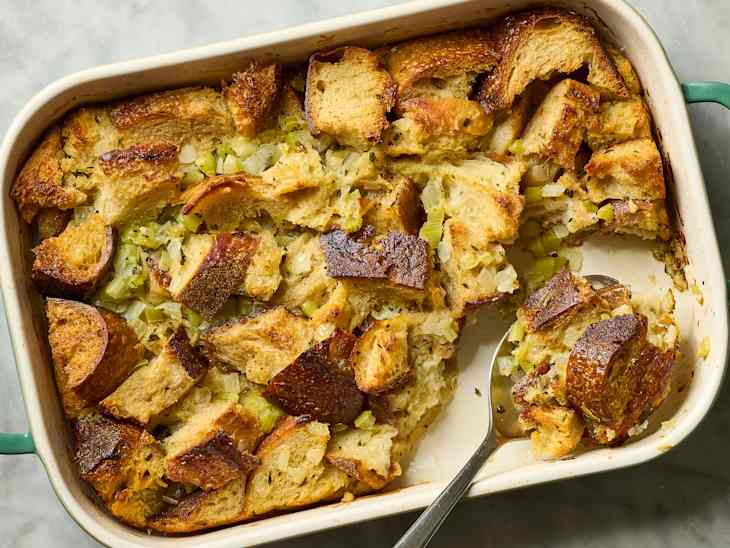 dish of bread stuffing, with a spoonful being taken out