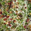 A bowl of Thanksgiving slaw with sliced almonds and cranberries