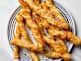 overhead shot of cheese twists on a white and blue striped plate