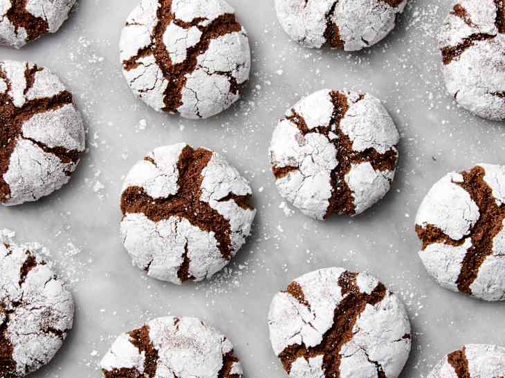 overhead shot of chocolate crinkle cookies on a marble surface