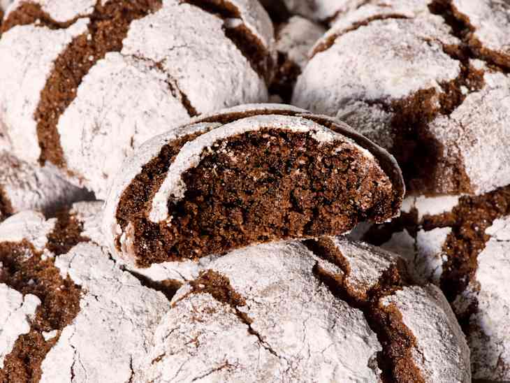 overhead shot. of a chocolate crinkle cookie with a bite taken from it