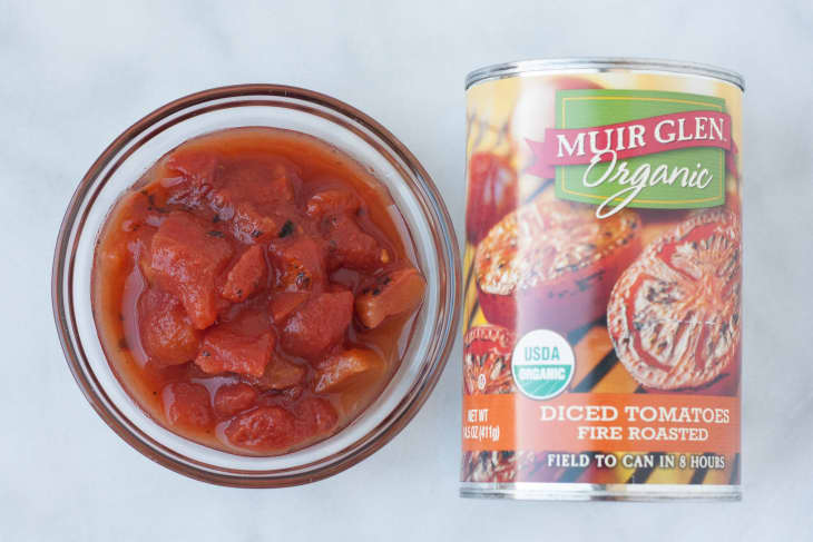 Bowl of diced fire-roasted tomatoes next to a can of Muir Glen Organic tomatoes.
