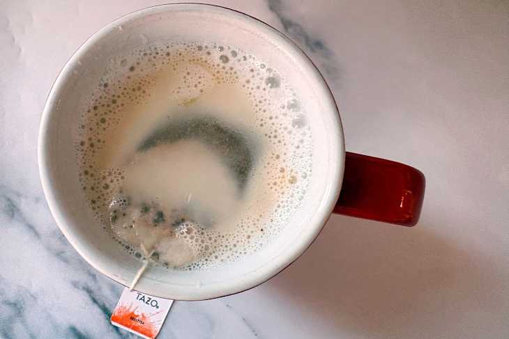 Christmas mug with early grey tea bag in hot chocolate