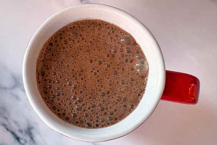 Christmas mug with early grey tea bag in hot chocolate