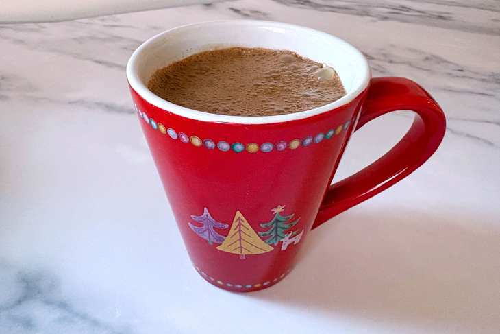 Christmas mug with early grey tea bag in hot chocolate