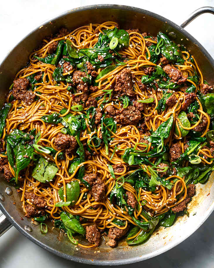 overhead shot of sesame noodles with ground beef and spinach
