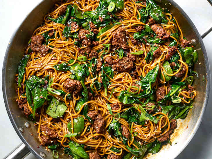 overhead shot of sesame noodles with ground beef and spinach