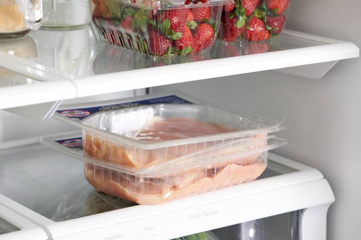 Two packages of raw chicken in the refrigerator