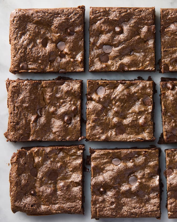 overhead shot of brownies cut into squares on a marble surface