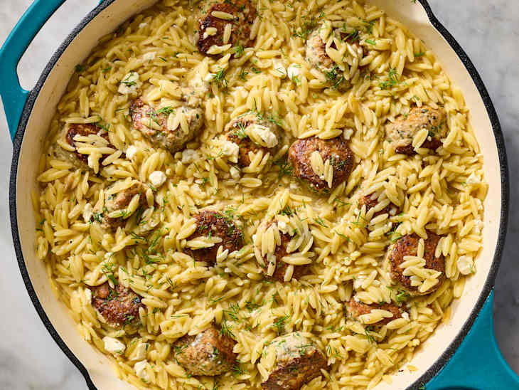 Orzo pasta mixed with meatballs, crumbled feta, and fresh dill