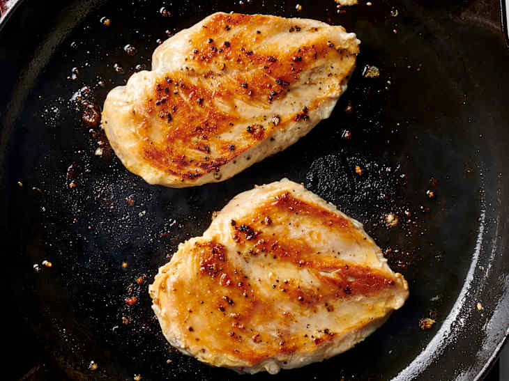 moist and tender chicken breast cooking in a cast iron skillet