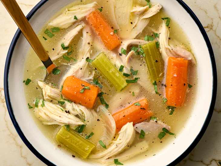 overhead shot of chicken soup in a bowl