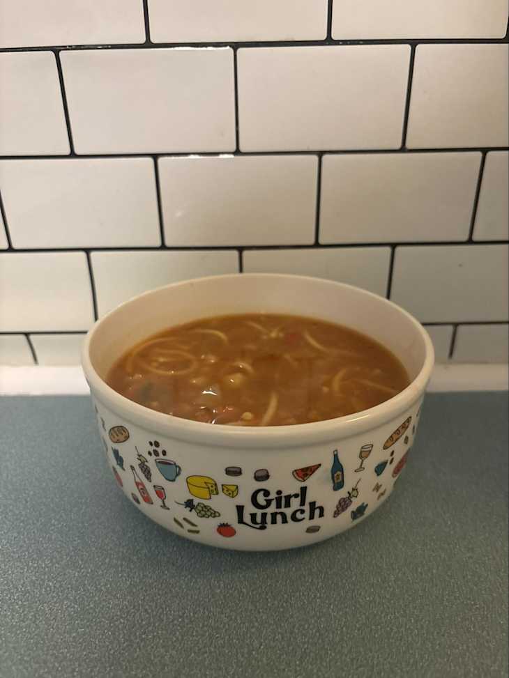 A bowl of fall harvest vegetable soup on a kitchen counter.