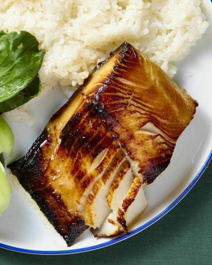 overhead shot of miso black cod on a plate with bok choy and white rice.