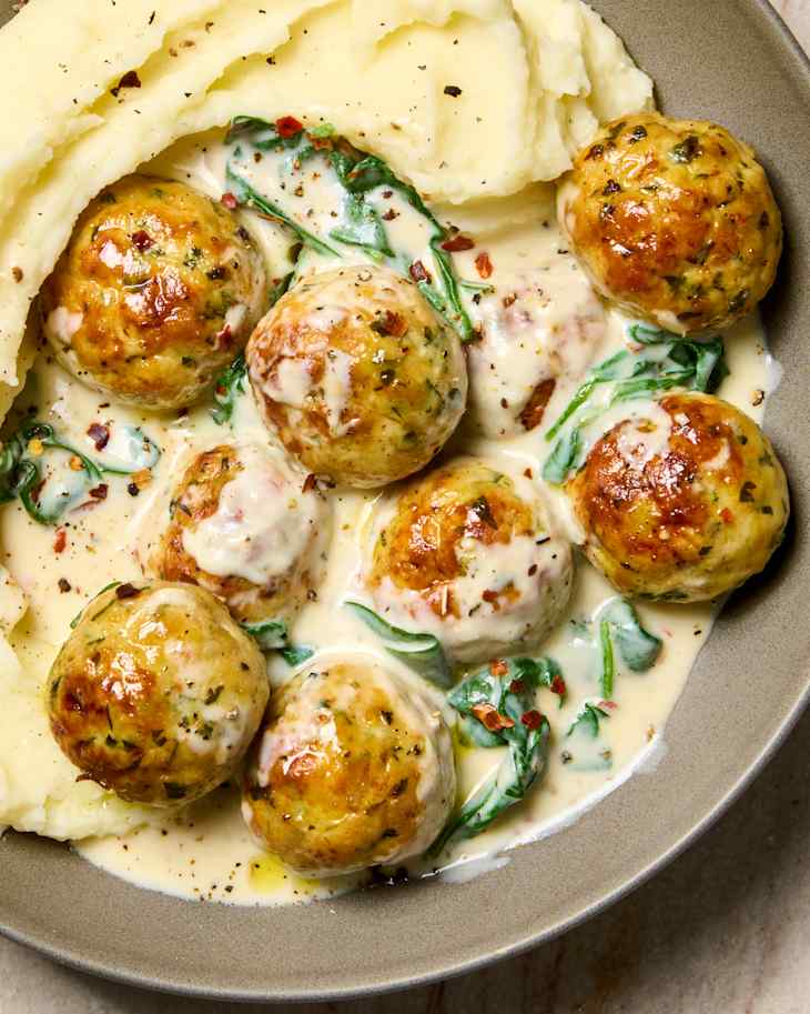 overhead shot of creamy spinach and chicken meatballs served over mashed potatoes