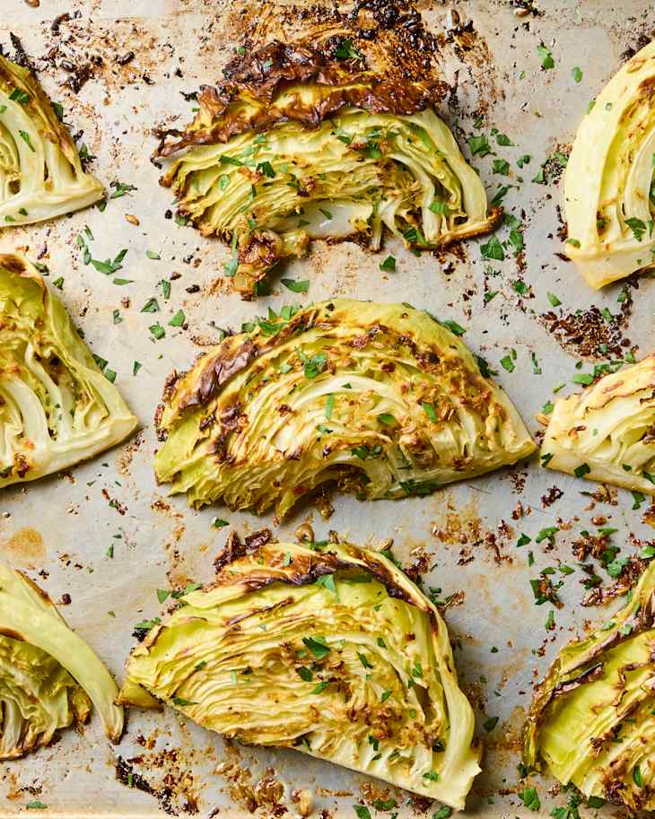 Roasted cabbage wedges on a baking sheet