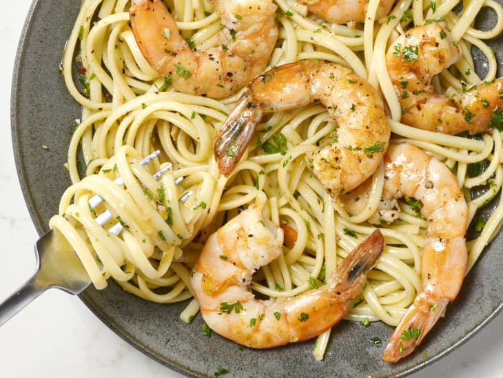 overhead shot of shrimp scampi served over spaghetti