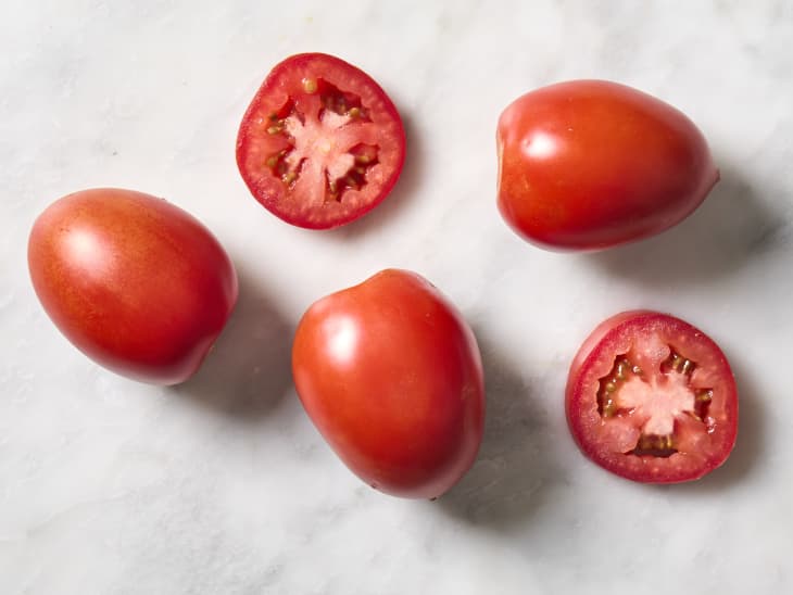 overhead shot of plum tomatoes on a marble surface
